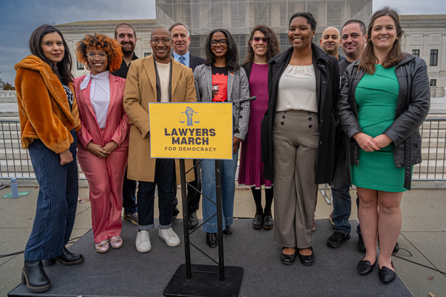Speakers in front of a podium at the Supreme Court